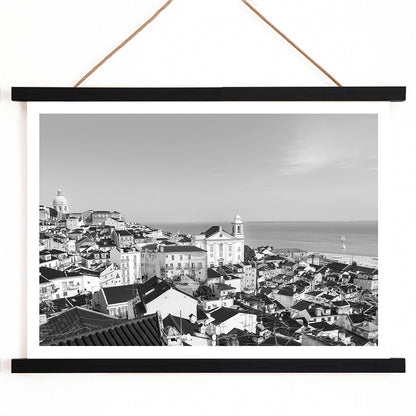 Black and white landscape poster of Alfama Lisbon Old City with traditional buildings and Tagus River by artist Alfama Lisbon, with wooden magnetic frame on white background