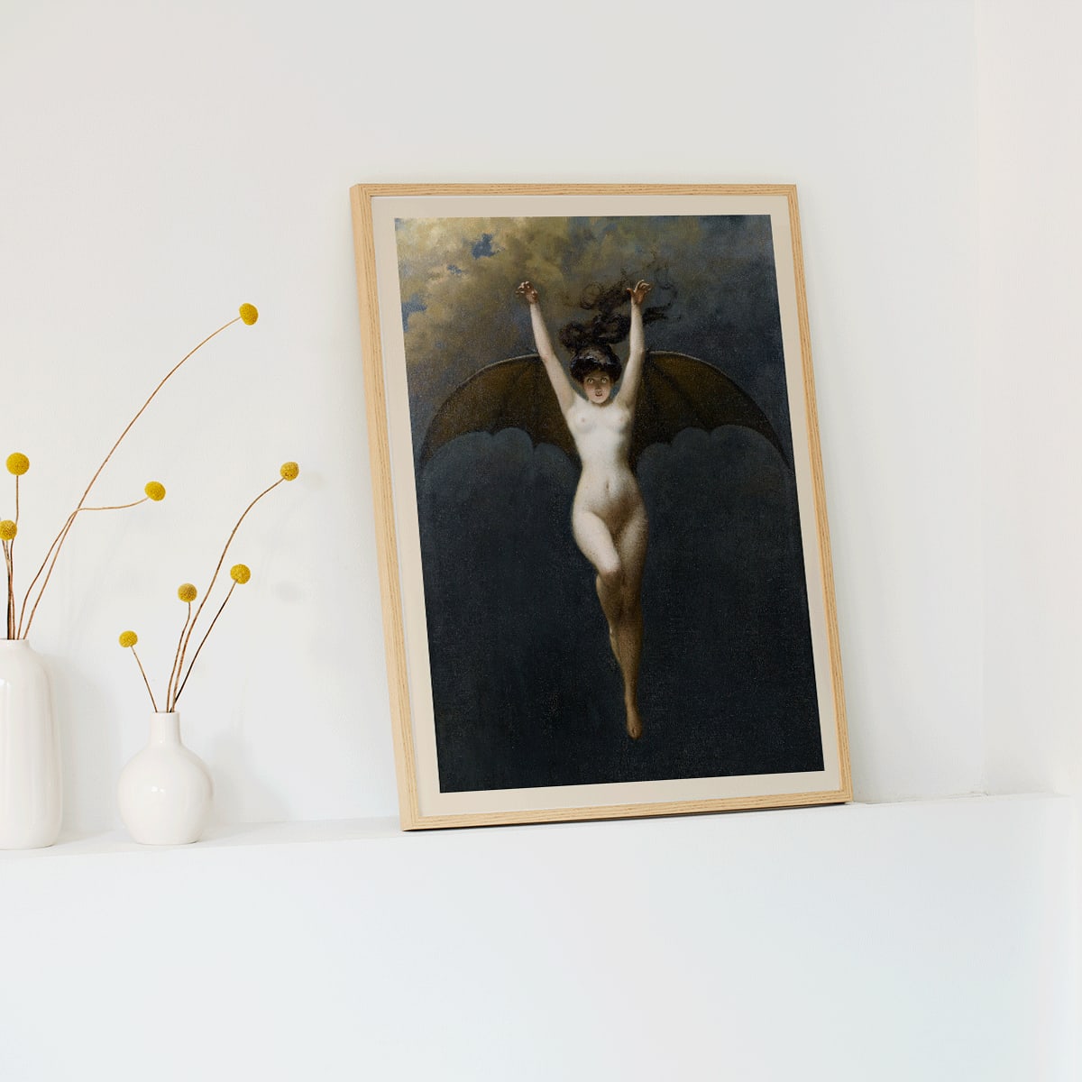 The Bat-Woman by Albert Joseph Penot artwork showing a woman with bat wings against a cloudy dark sky, framed and displayed in modern living room decor