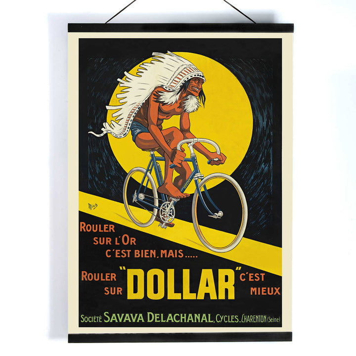 Michel Liebeaux Dollar Bicycles poster with advertising cyclist, white headdress, yellow circle, black background and bold orange lettering, with wooden magnetic frame on white background