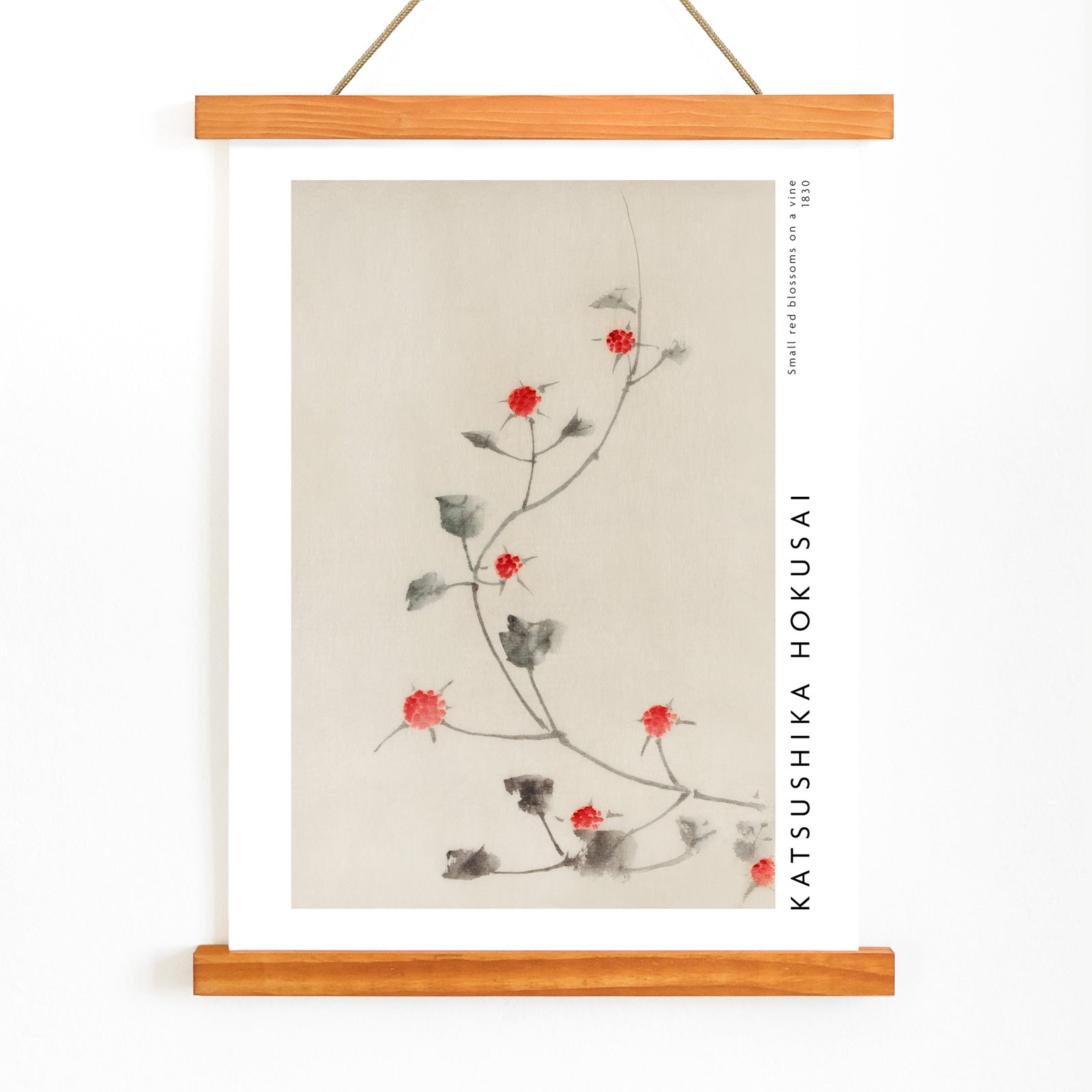 Small Red Blossoms on a Vine artwork by Katsushika Hokusai featuring delicate red flowers and green leaves on a light background, with wooden magnetic frame on white background