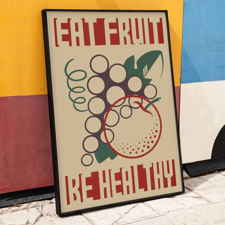 Work Projects Administration Eat Fruit Be Healthy poster with bold red type and stylized fruit, framed and displayed in home decor
