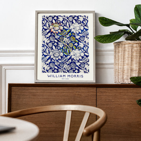 Floral fabric pattern and watercolour poster with intricate blue and white design by William Morris Wey, framed and displayed in home decor