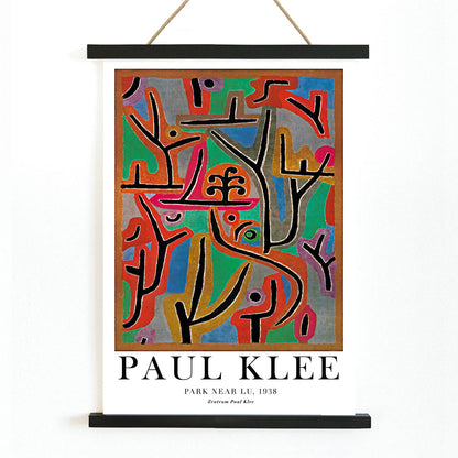 Exhibition poster of Park Near Lu by Paul Klee featuring vibrant abstract shapes and bold lines in diverse colors, with wooden magnetic frame on white background
