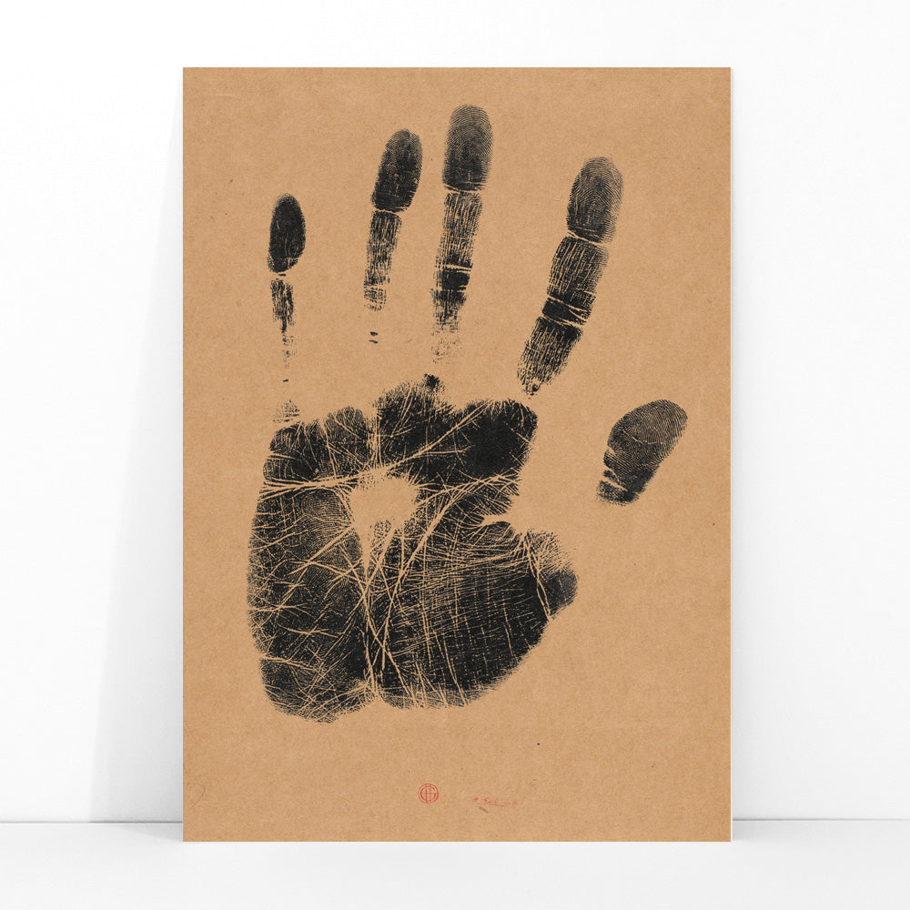 Black ink handprint artwork titled The Artists Left Hand by Henri Charles Guerard on beige background, framed and displayed in modern living room decor