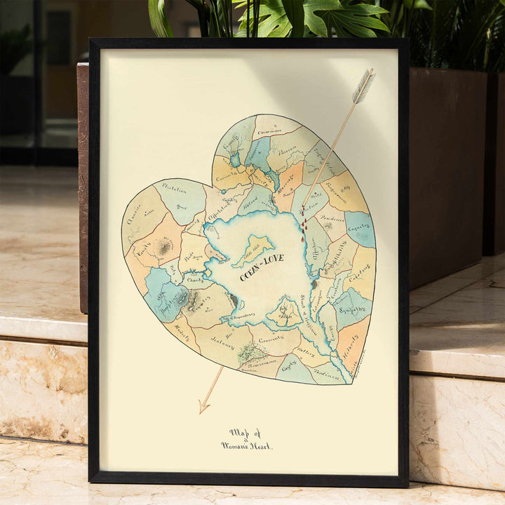Joseph Husson Map of a Womans Heart 2 poster featuring a heart shaped map with an arrow, soft pastel blue and beige details, vintage style, framed and displayed in home decor