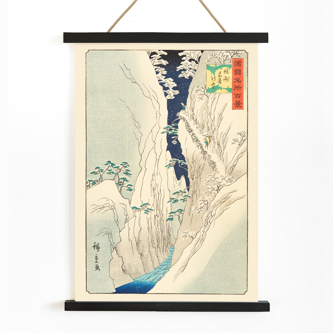 Snowy mountain gorge with river travelers and trees in The Kiso Gorge in Snow Shinano Province by Hiroshige II Japanese artwork poster, with wooden magnetic frame on white background