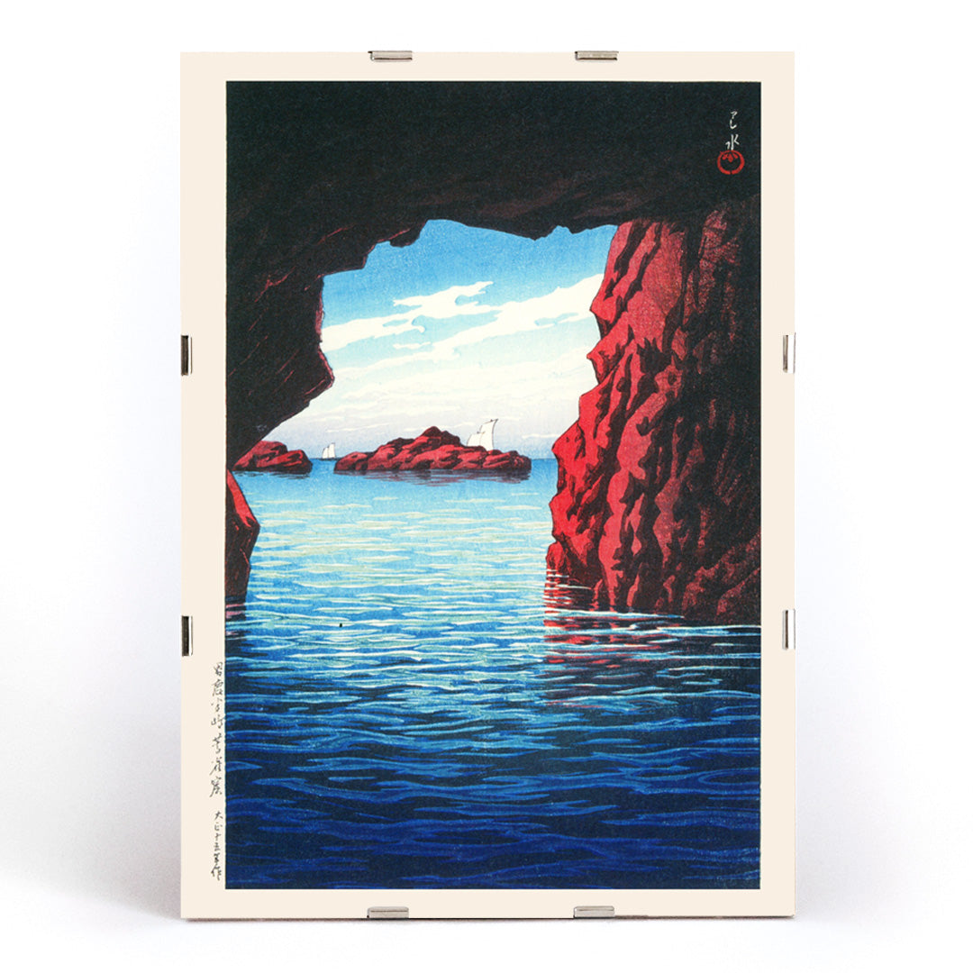 Kojaku Cavern Oga Peninsula sea cave with blue water and red cliffs vibrant sea cliffs and water by Kawase Hasui, framed and displayed in modern living room decor