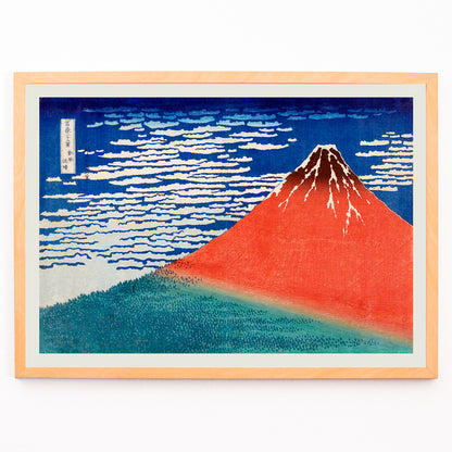 Closeup detail of Fine Wind Clear Morning by Katsushika Hokusai poster showing red Mount Fuji under blue sky with white clouds