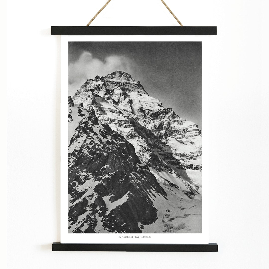 Black and white photograph and poster of K2 west face by Vittorio Sella showing the snow-covered mountain peak, with wooden magnetic frame on white background