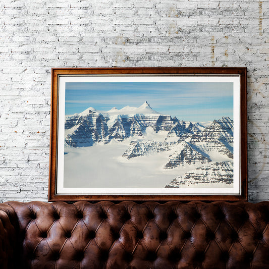 Snow covered mountain ridges and unique geology of the Geikie Plateau eastern Greenland by NASA poster, framed and displayed in home decor