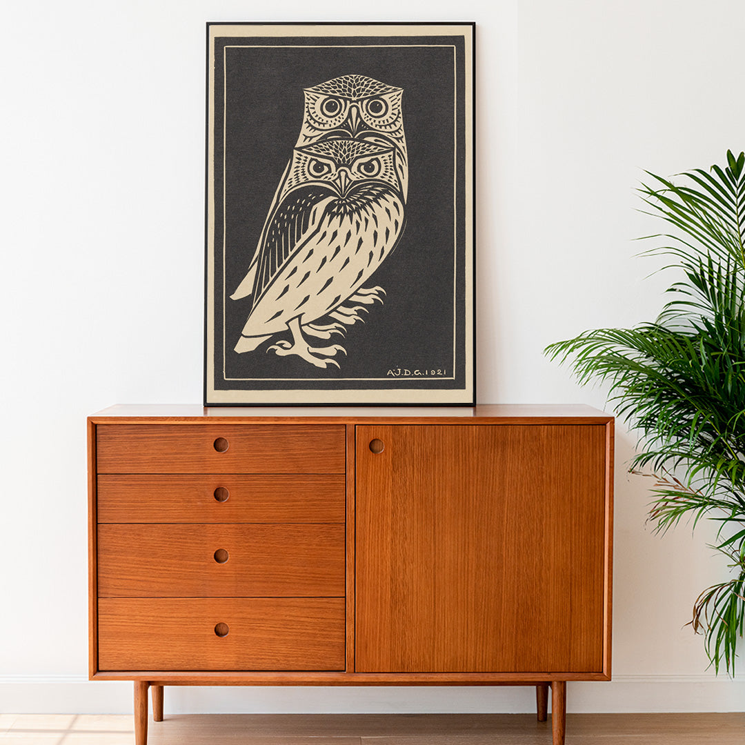 Stylized black and white owls artwork by Julie de Graag titled Two black and white owls illustration and poster, framed and displayed in home decor