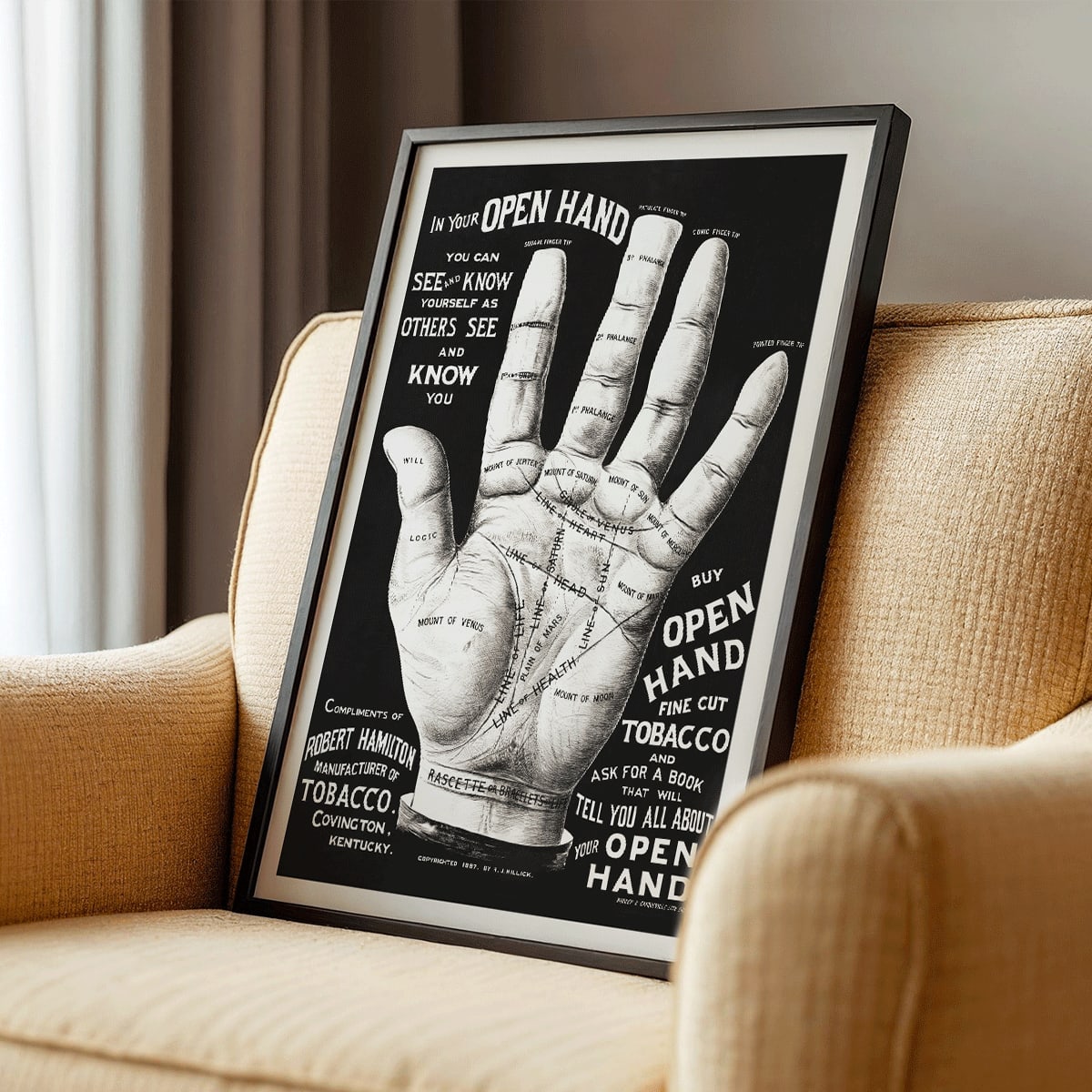 Palm reading diagram and detailed palm poster with labeled lines and mounts artwork titled Open hand by R J Millock and J Halleck, framed and displayed in modern living room decor