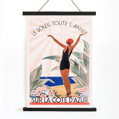 Woman in swimsuit enjoying sunny beach scenery surrounded by flowers Cote dAzur artwork by Roger Broders, with wooden magnetic frame on white background