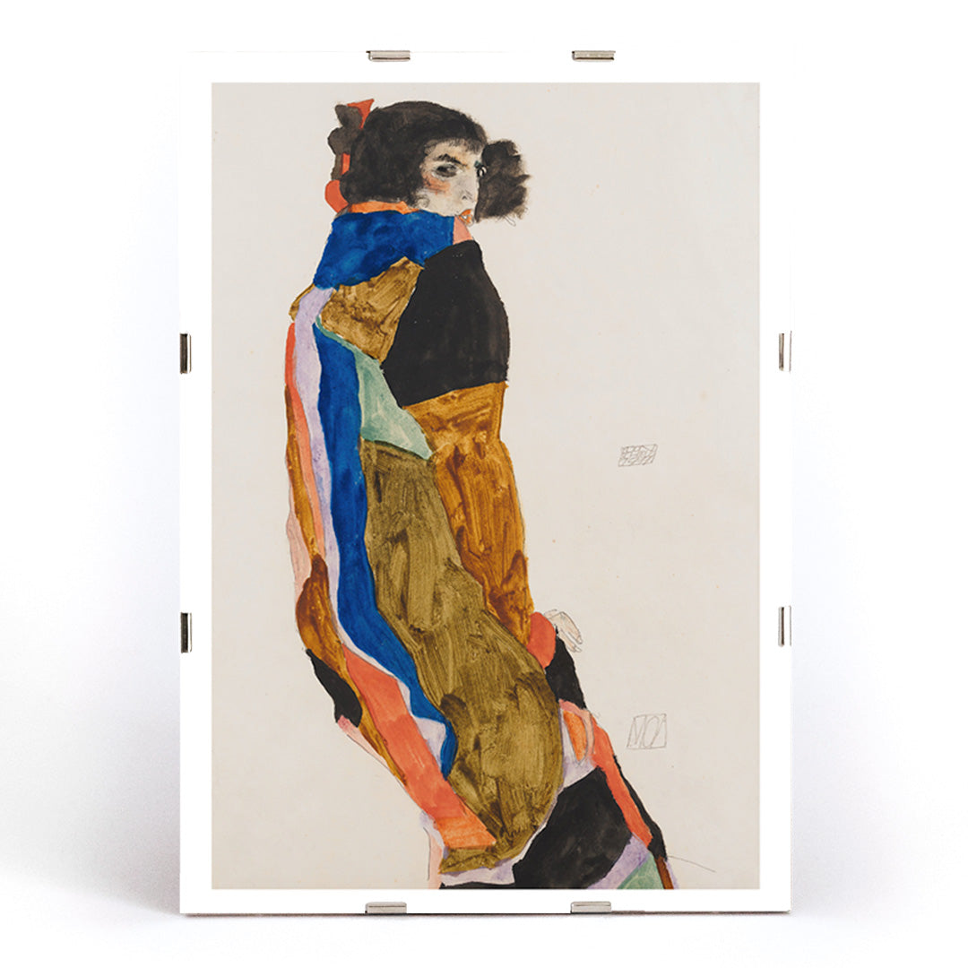 Colorful portrait poster of a woman in a patterned robe looking back Moa by Egon Schiele expressive art print, framed and displayed in modern living room decor