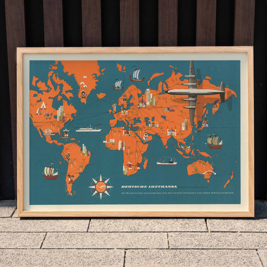 Vintage aviation map art and vibrant world map poster with planes ships and landmarks by Deutsche Lufthansa, framed and displayed in home decor