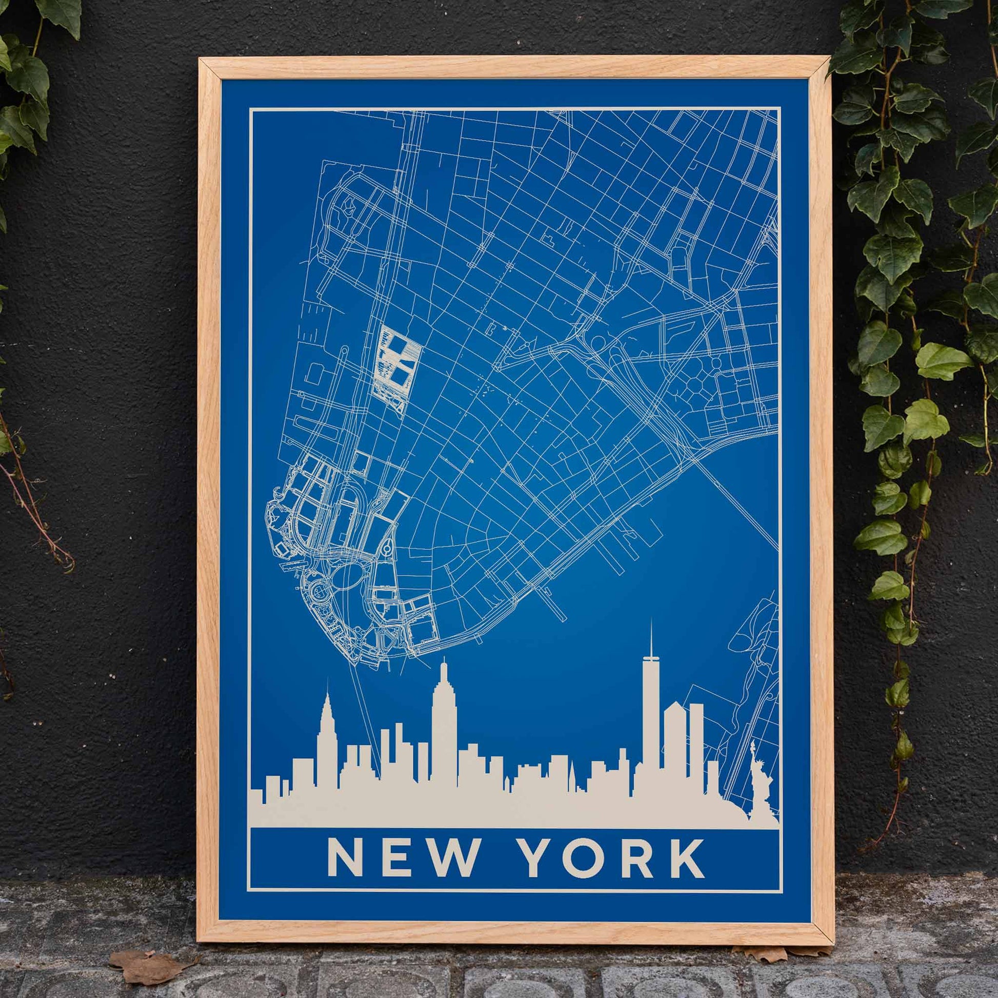 New York Minimalist Map poster by artist New York featuring a blue and white outline of New York City streets above a city skyline silhouette, framed and displayed in home decor