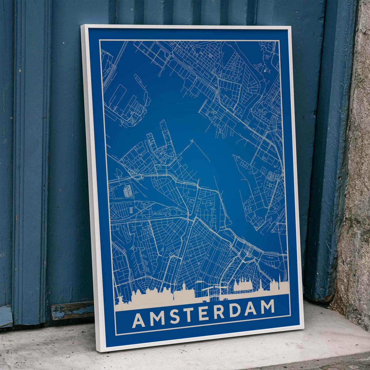 Amsterdam minimalist map artwork poster in blue and white showing detailed city streets and waterways, framed and displayed in home decor