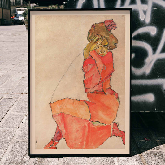 Kneeling Female in Orange Red Dress by Egon Schiele expressive painting poster showing a woman in a vibrant pose, framed and displayed in home decor