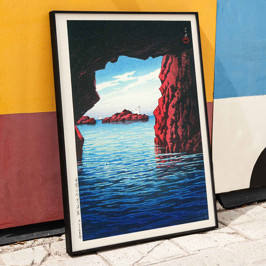 Kojaku Cavern Oga Peninsula sea cave with blue water and red cliffs vibrant sea cliffs and water by Kawase Hasui, framed and displayed in home decor