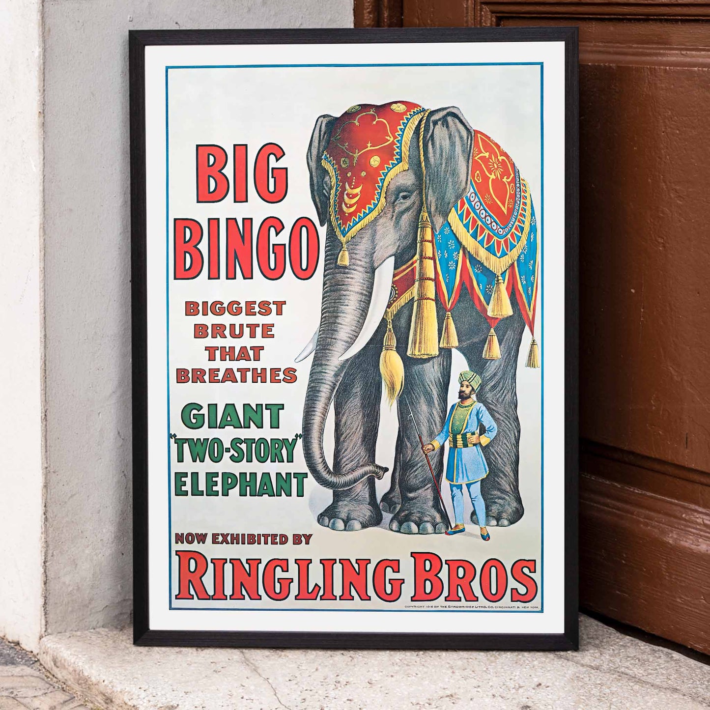 Colorful circus elephant and trainer poster artwork featuring Big Bingo a decorated giant elephant and circus keeper with vibrant circus themed graphics, framed and displayed in home decor