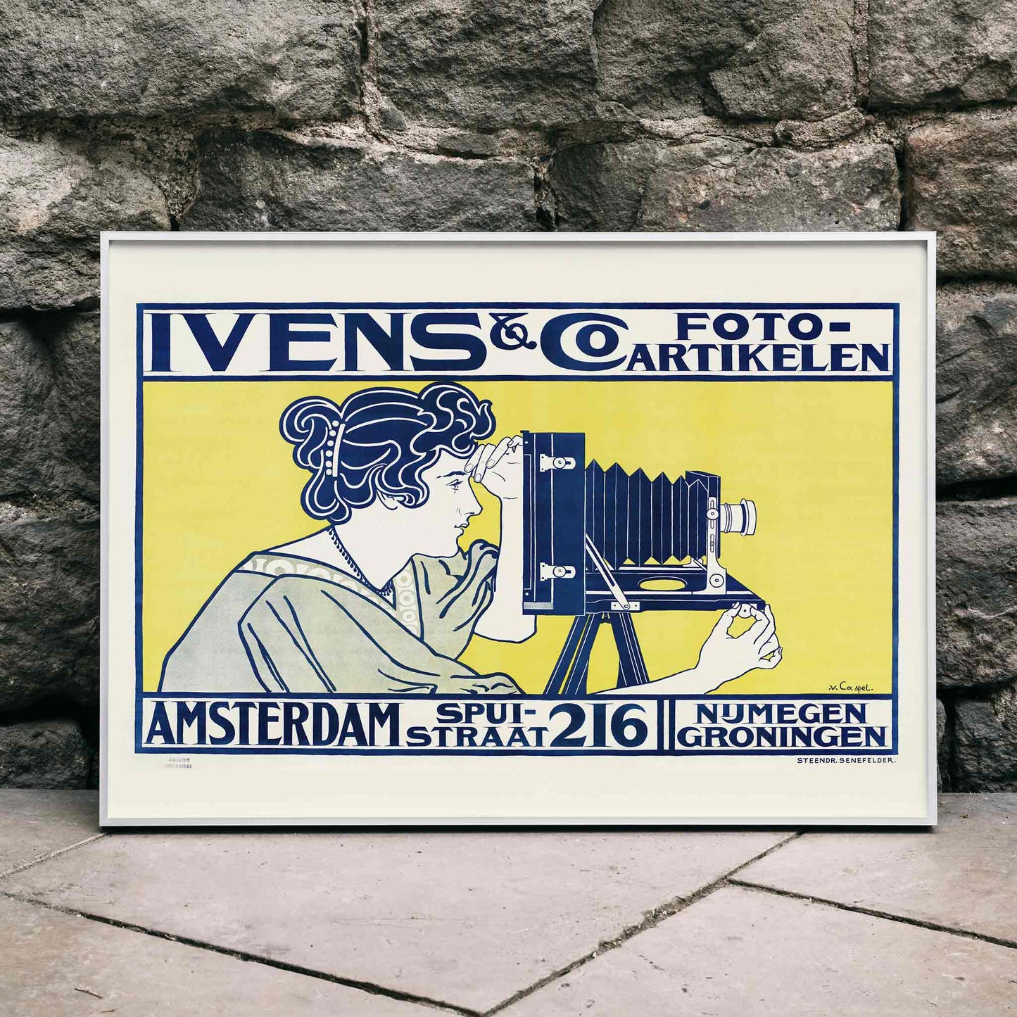 Art nouveau poster of woman using vintage camera at Ivens and Co Camera Shop by Johann Georg van Caspel, framed and displayed in home decor