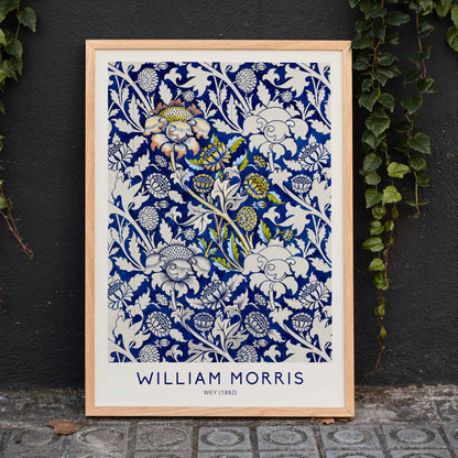 Floral fabric pattern and watercolour poster with intricate blue and white design by William Morris Wey, framed and displayed in home decor