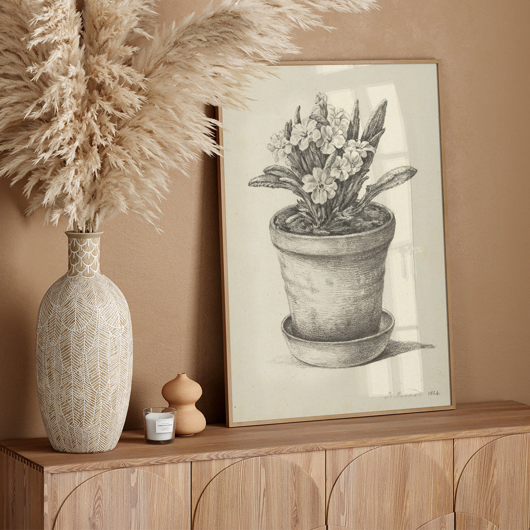 Black and white pencil drawing poster of a flowering plant in a clay pot titled Potplant by Jean Bernard, framed and displayed in home decor