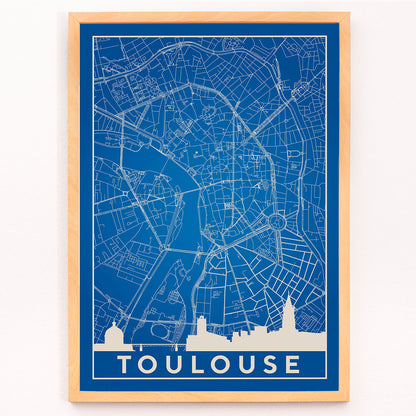 Blue and white minimalist map of Toulouse poster with white building silhouettes at the bottom modern wall art titled Minimalist Toulouse Map, framed and displayed in modern living room decor