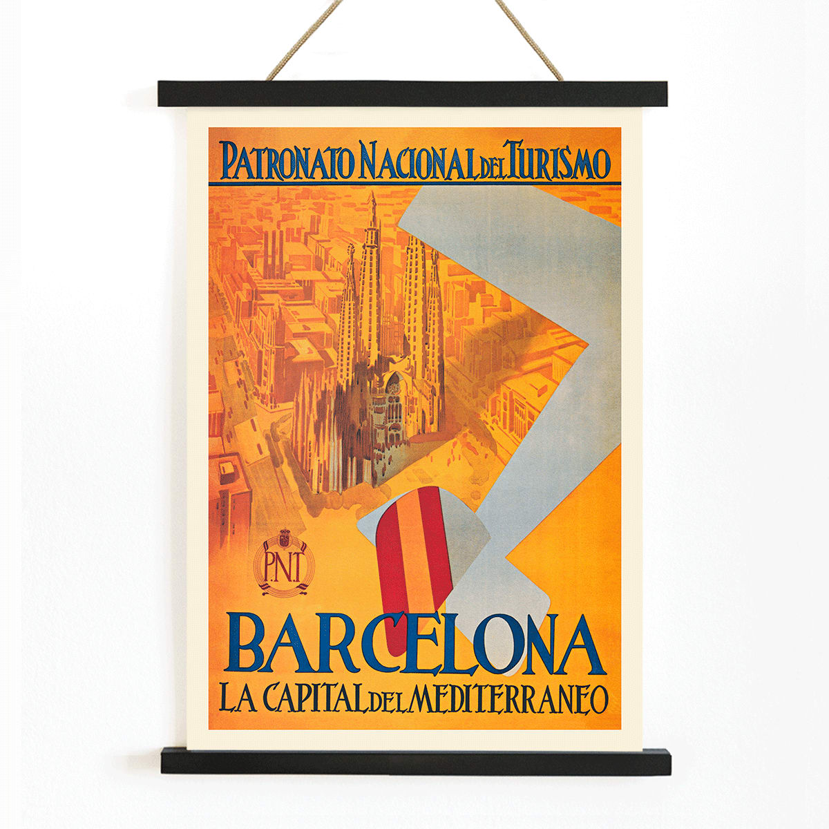 Barcelona La Capital del Mediterraneo poster by Patronato Nacional del Turismo featuring city skyline cathedral cityscape and flying flag, with wooden magnetic frame on white background